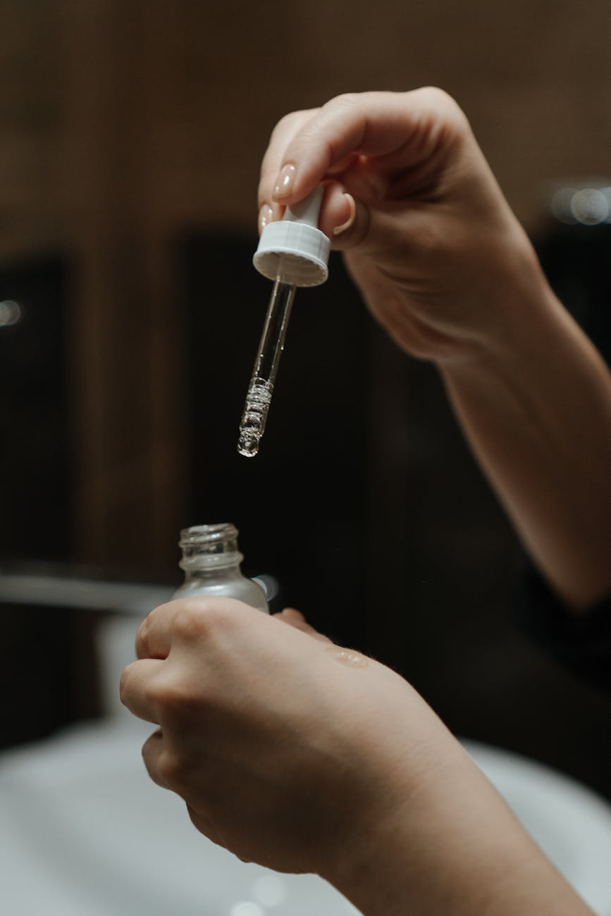 person holding white plastic bottle